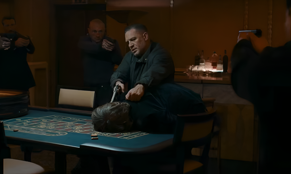 Tom Hardy as Harry pulls a gun at Johnny Flynn as Frankie in MobLand Season 2 Episode 7