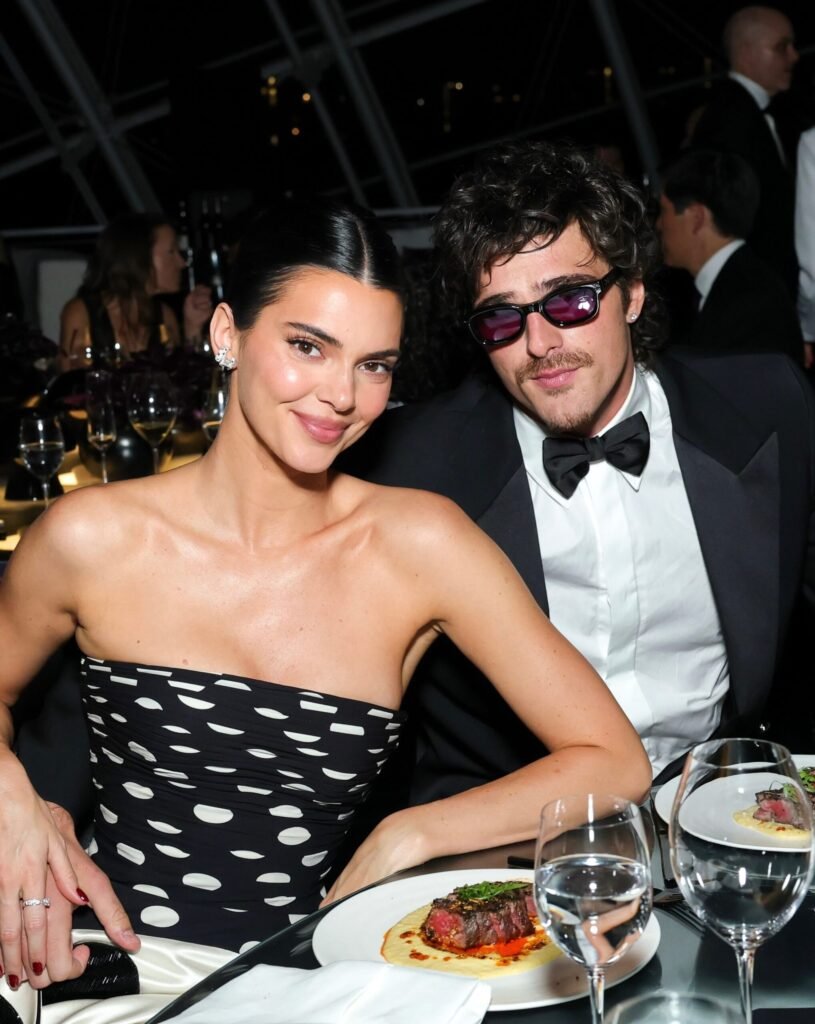 Kendall Jenner and Jacob Elordi smiling together at a formal event, captured from Vanity Fair on Instagram.