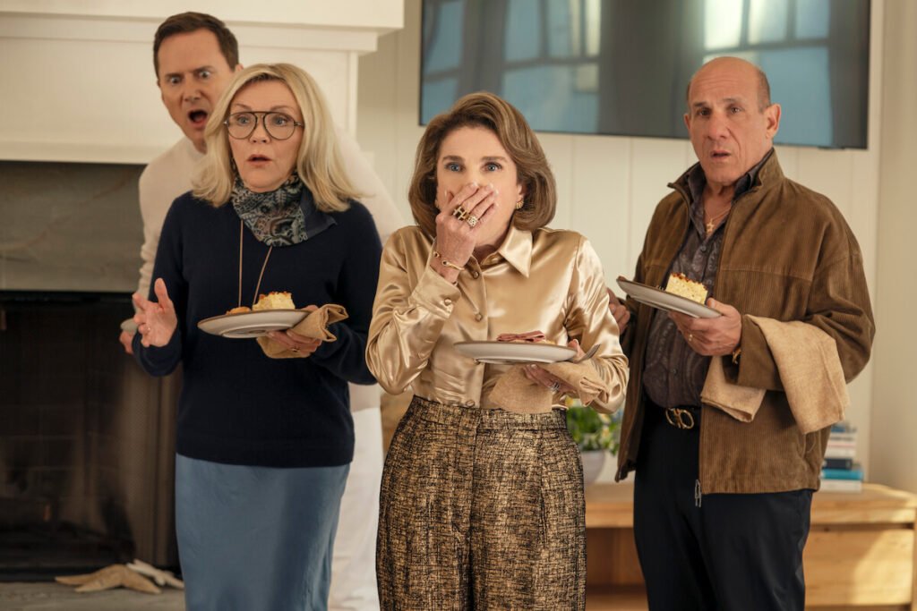 Henry, Lynn, Bina, and Ilan looking shocked and holding plates of food in a scene from Nobody Wants This Season 3.