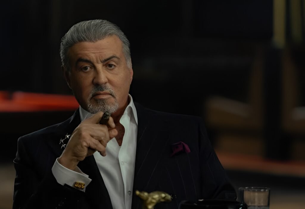 Sylvester Stallone as Dwight Manfredi sitting in a church pew in Tulsa King Season 4
