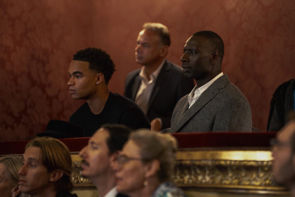 Théo Christine as Raoul and Assane Diop (played by Omar Sy), in a court setting in Lupin part 4.