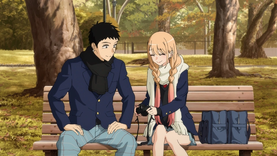 Marin Kitagawa and Wakana Gojo sitting together on a park bench reviewing photos on a camera in My Dress-Up Darling.
