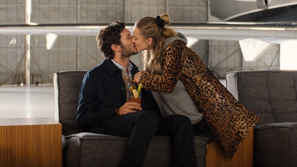 Kristen Bell as Joanne and Adam Brody as Noah sharing a kiss in a scene from Nobody Wants This Season 3.