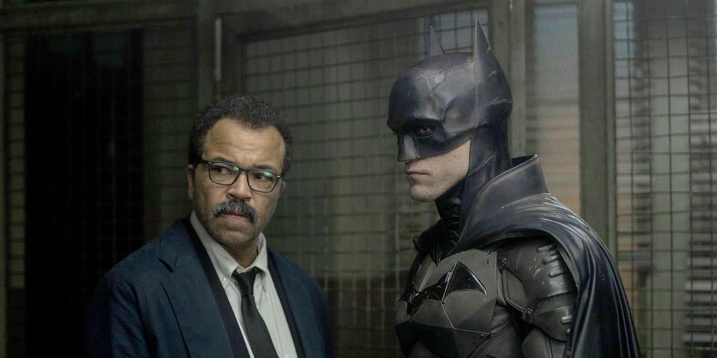 Jeffrey Wright as Jim Gordon stands beside Robert Pattinson's Batman in a Gotham police station. Both will return in The Batman: Part II according to Steven Soderbergh